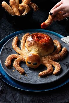 a flyer for a halloween party with an octopus on it's face and bread in the shape of a pumpkin