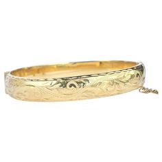 This gorgeous rolled 9 carat gold bangle has wonderful engraving. Inner diameter widest point: 6cm Inner circumference: 17.5cm Bangle Width: 10mm Weight: 11.7g Luxury Engraved Ornate Bangle, Luxury Vintage Engraved Cuff Bracelet, Classic Gold Etched Bangle, Engraved Bangle For Formal Occasions, Formal Etched Gold Bangle Bracelet, Etched Yellow Gold Bangle For Anniversary, Anniversary Etched Gold Bangle Bracelet, Engraved Bangle, Gold Engraving