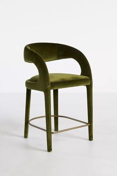 a green chair sitting on top of a white floor