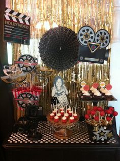 a table topped with lots of cupcakes and candy