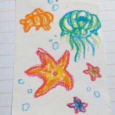 an image of children's drawing on paper with colored pencils and watercolor crayons