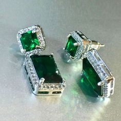 💚 Elevate your style with our Lab-Created Green Emerald Square Drop Earrings, beautifully plated with 18k White Gold. Perfect for creating an elegant, royal look. 💎 Shop now! #uniquefashionjewelryboutique #jewelryart #jewelryshop #jewelryaddict #finejewelry Luxury Sterling Silver Rectangular Earrings, Gift Cubic Zirconia Earrings With Plating, Luxury Rectangular Earrings As Gift, Luxury Single Earring For Gift, Luxury Rectangular Earrings For Gift, Gift Earrings With Cubic Zirconia Plating, Green Rectangular Earrings For Formal Occasions, Rectangular Cubic Zirconia Earrings For Gifts, Elegant Green Rectangular Earrings