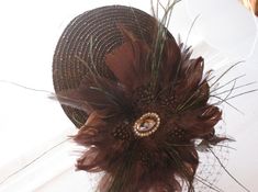 This Chocolate Brown Feather and Crystal Fascinator Hat with Veil and Crystal Headband is a beautiful accessory for weddings, parties, cocktail, evening, and other special occasions. This hat is fashionable, elegant, and sophisticated. It is definitely a statement piece and will add something special to your outift!  I only accept PayPal and ship all orders within 24 hours via USPS. Feel free to send me a convo with any questions you may have. Thank you for visiting Hettie Hair Accessories! Elegant Mini Hats With Feather Trim For Party, Elegant Feather Trim Top Hat For Party, Elegant Party Costume Hats And Headpieces With Feather Trim, Elegant Party Top Hat With Feather Trim, Elegant Feathered Headpiece For Vintage Events, Elegant Mini Hats With Feathers For Gifts, Elegant Mini Hat With Feathers As Gift, Elegant Mini Hats With Feathers As Gifts, Elegant Mini Hat With Feathers For Gift