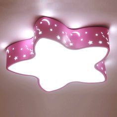 a pink ceiling light with stars and moon designs