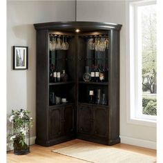 a tall wooden cabinet with wine glasses on it