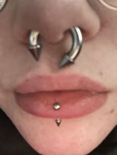 a woman with metal piercings on her nose