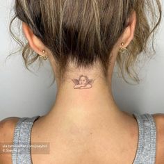 a woman with a small tattoo on her neck