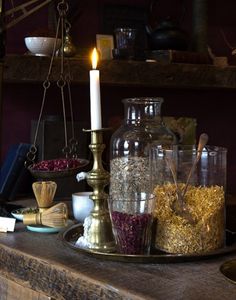 black and white photograph of candles, glass jars and other items