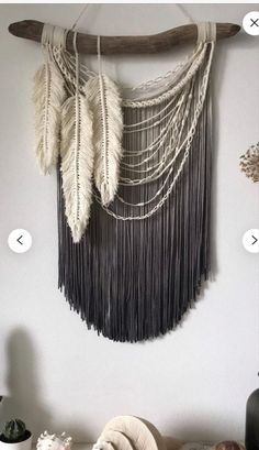 the wall hanging is decorated with beads and feathers