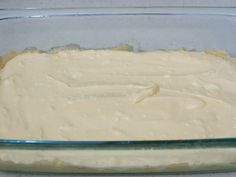 a glass dish filled with batter on top of a counter