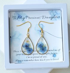 To My Precious Daughter Earrings | Forget Me Not Flower Earrings | Dangle Drop Earrings | Real Pressed Flower Earrings | Gift for Daughter | Birthday Gift for Her 🌿The "To My Precious Daughter" Forget Me Not Flower Earrings are a stunning and sentimental piece of jewelry that serves as a heartfelt gift for daughters. These earrings feature real forget-me-not flowers that have been delicately pressed and encased in epoxy resin, creating a unique and eye-catching design. 🌿The dangle drop style a Pressed Flower Earrings, Earrings Real, Forget Me Not Flower, My Precious, Gift For Daughter, Birthday Gift For Her, Pressed Flower, Daughter Birthday, Drops Design