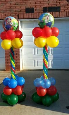 some balloons are on top of each other in front of a garage with a fire hydrant