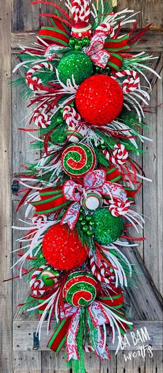 a christmas tree made out of candy canes and other holiday decorations on a wooden background