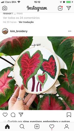 someone is showing off their hand embroidered heart - shaped flowers on the appliance