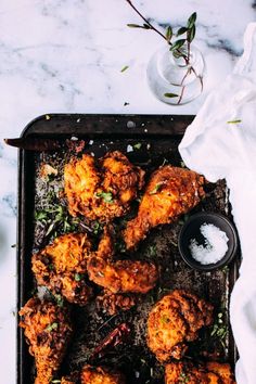 chicken wings on a baking sheet with salt and pepper