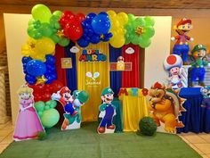 the balloon arch is decorated with mario and luigi's characters for a birthday party