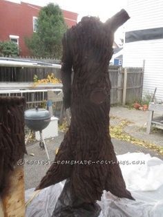 a large tree trunk sitting on top of a plastic tarp