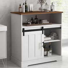 a white cabinet with some bottles and towels on it