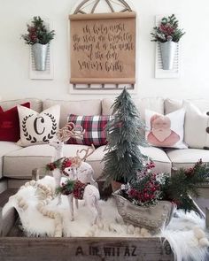 a living room decorated for christmas with deer figurines on the coffee table and other holiday decorations