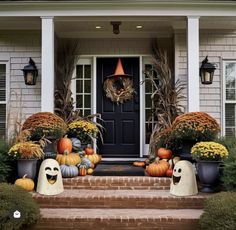 front porch decorated for halloween with pumpkins and gourds