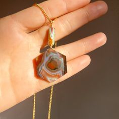 Swirling multi-toned natural agate that has a little red heart-eye on the right and mirrors the pathways molten fire-rock would take. Lava is semi-fluid rock. A reminder that all rocks and stones in nature have life and can move, transform, change, and evolve. Just like us. A symbol of great power in the natural world, lava holds this impression deeply imprinted in our consciousness. A talisman to connect to the bubbling emotions swirling just below the surface. Bring consciousness to them. Let Spiritual Agate Gemstones As Gift, Bohemian Agate Geodes As A Gift, Large Agate Gemstone As A Gift, Large Agate Stone Gemstone For Gift, Bohemian Agate Geodes, Bohemian Geodes For Healing, Unique Agate Geodes, Bohemian Natural Stone Geodes For Healing, Unique Raw Stone Geodes For Healing