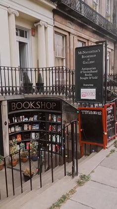 bookshop on the sidewalk in front of an old building with wrought iron railings