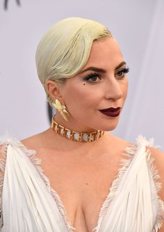 lady in white dress with blonde hair and statement earrings