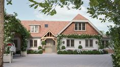 a large house with lots of windows and plants on the front door is surrounded by greenery