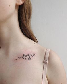 a woman with a small tattoo on her chest