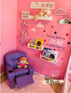 a child's room with pink walls and toys on the wall, including a purple chair