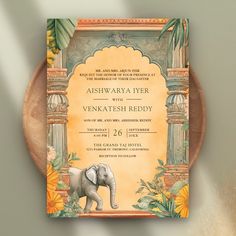 an elephant is standing in front of a yellow and orange wedding card with flowers on it