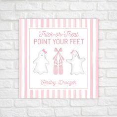 a pink and white poster on a brick wall with the words trick or treat point your feet