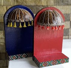 two wooden boxes with bells on them sitting next to each other