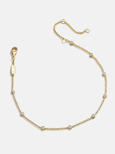 We took our classic Yasmine 18K Gold Bracelet and turned it into your new favoite anklet. The Yasmine 18K Gold Anklet features both contemporary chain and high-shine Cubic Zirconia bezel stones. Each stone is separated by elegant chain, ensuring they all get their individual spotlight. Not to mention, this piece is crafted with 18K gold plated sterling silver, so you can wear it again and again for years to come. Classic Gold Bracelet With Satellite Chain, Elegant Yellow Gold Anklets With Delicate Chain, Yellow Gold Delicate Chain Anklet, Elegant Yellow Gold Chain Anklets, Gold Adjustable Dangle Anklets, Anklets Gold, Gold Plated Anklet With Adjustable Chain, Elegant 14k Gold-filled Gold Anklets, Gold-plated Adjustable Anklets