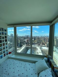 a bedroom with a large window overlooking the city