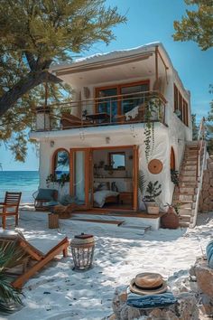 a house on the beach with stairs leading up to it