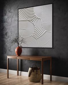 a vase sitting on top of a wooden table in front of a wall with an abstract design