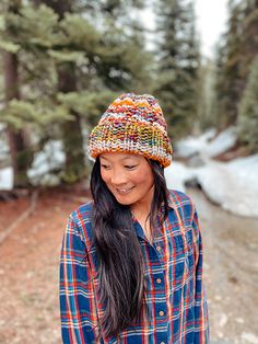 a woman wearing a plaid shirt and a knitted hat