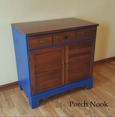 a blue and brown cabinet sitting on top of a hard wood floor