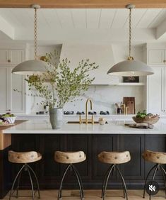 three stools are in front of the kitchen island