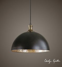 a black and gold pendant light hanging from a ceiling