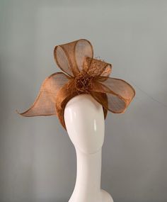 Here i have handed a Bronze coloured crown hat / fascinator adorned with a sculptured bow and merry widow veiling. With headband & millinery elastic attachment. Like this style in another colour ?   message me for details. Colour samples are available upon request. Party Hat With Bow And Curved Brim, Curved Brim Mini Hat With Bow For Party, Adjustable Mini Hats With Bow For Kentucky Derby, Summer Party Hair Accessory With Decorative Bow, Curved Brim Bow Fascinator For Party, Party Fascinator With Bow And Curved Brim, Party Hat With Bow For Royal Ascot, Party Fascinator With Curved Brim And Bow, Royal Ascot Party Hat With Bow