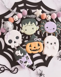 halloween decorated cookies are arranged on a table