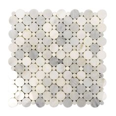 a white and grey mosaic tile with circles on the bottom, in various sizes and colors