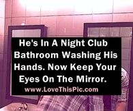 a man is in the bathroom washing his hands, and he's on the mirror