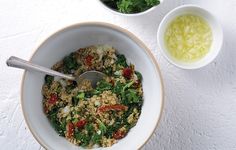 a bowl filled with rice and vegetables next to two bowls