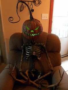 a skeleton sitting on top of a brown couch