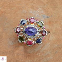 Tanzanite Gemstone Ring, Ruby Gemstone Ring, Sapphire Gemstone Ring, Pave Diamond Jewelry, 925 Silver Jewelry, Gold Vermeil Jewelry, Gifts Gross Weight: 16.34 gram Diamond Weight: 1.20 cts Gemstone Weight: 16.85 cts Ring Size: 38X34 MM NOTE:- All The Products Are Designed And Manufactured In My Workshop By Me & My Team. Shown Products Are Purely Handmade. Custom Orders Are Open Handly Accepted. We Are the Perfect Choice For Any Custom Jewelry Manufacturing. For Bulk Orders Please Message me. Multicolor Amethyst Ring Fine Jewelry, Multicolor Round Gemstones With Stone Setting, Multicolor Gemstone Cluster Ring, Multicolor Ruby Ring With Gemstone, Multicolor Round Ruby Ring, Multicolor Oval Amethyst Gemstone Ring, Multicolor Center Stone Ring, Oval Multi-stone Flower Ring Gift, Oval Multi-stone Flower Ring For Anniversary