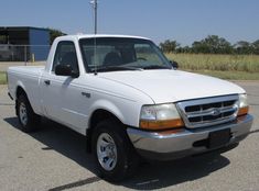 a white pick up truck parked in a parking lot