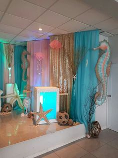 an ocean themed stage set up for a children's birthday party with seahorses and starfish